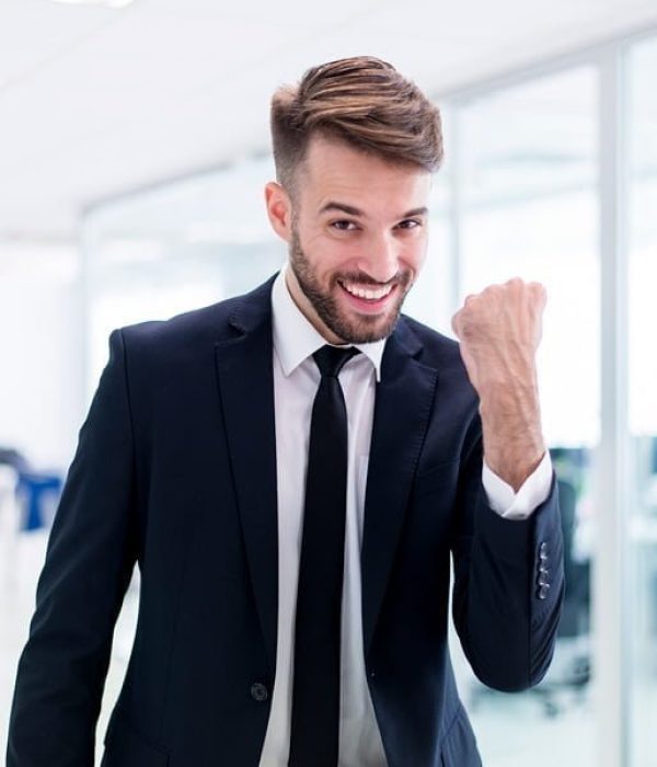 smiling-elegant-man-with-one-fist-raised